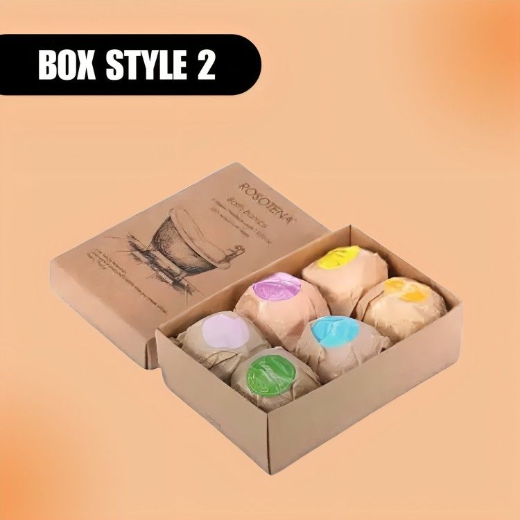 Brown box labeled "Box Style 2" contains wrapped items with colored stickers—purple, yellow, blue, green. The tone is warm and inviting.