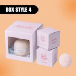 Packaging for a "Splash" bath bomb in pastel boxes labeled "peach flavor" and "Box Style 4." A bath bomb is visible, conveying a fresh, calming vibe.