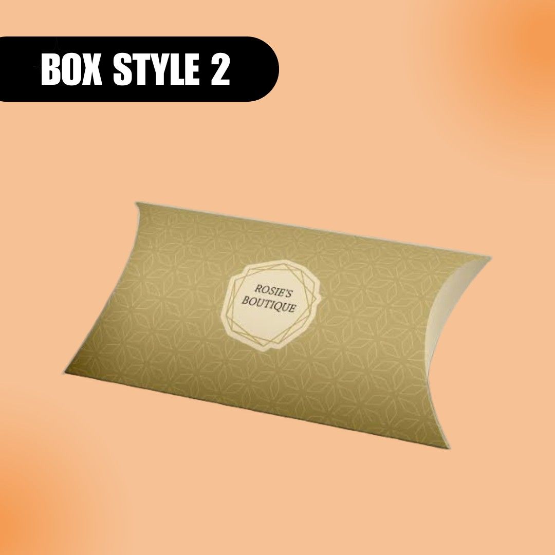 "Pillow-shaped box labeled 'Rosie's Boutique' with geometric patterns on a light brown background. Text 'Box Style 2' in bold, upper left. Elegant and classy design."